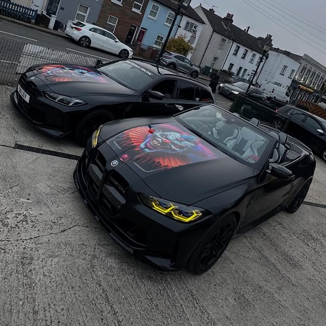 Two black Driftclown-liveried BMWs parked together